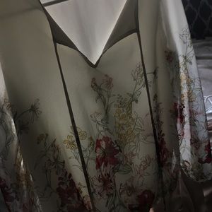 A white/cream and floral blouse